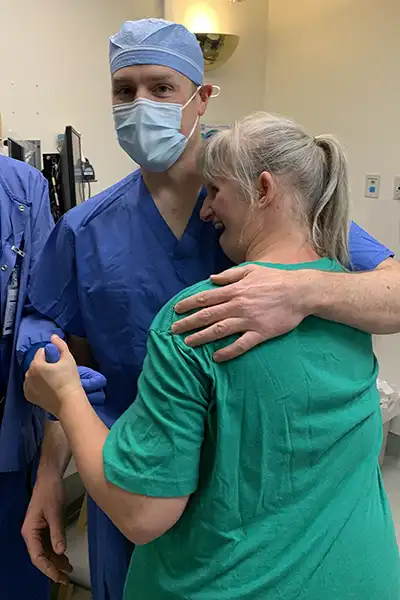 Brian R. Summers, DMD, PhD with arm around a patient at Special Care Dentistry of Oregon in Albany, OR