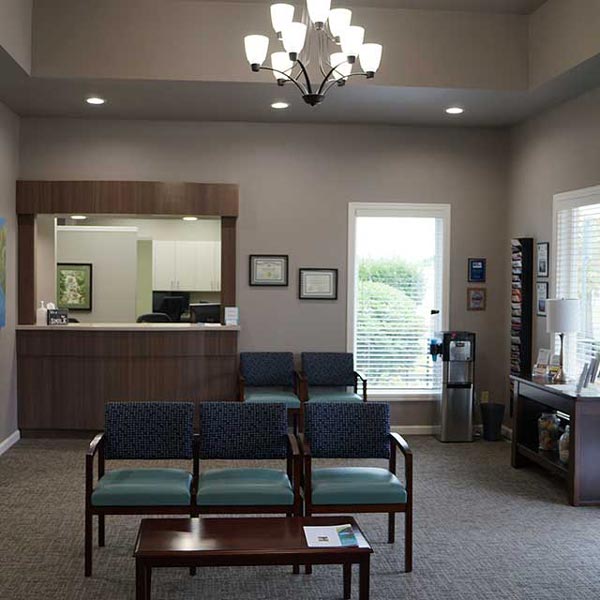 Waiting area with chairs in front of reception desk at Special Care Dentistry of Oregon in Albany, OR
